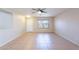 Large, empty living room with tile flooring and ceiling fan at 645 W Kingman Loop, Casa Grande, AZ 85122