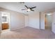 Spacious carpeted main bedroom with ceiling fan and ensuite bathroom with vanity at 645 W Kingman Loop, Casa Grande, AZ 85122