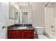 Bathroom showcasing vanity with granite countertop, mirror, and tiled shower at 681 W Racine Loop, Casa Grande, AZ 85122