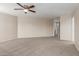 Large primary bedroom featuring neutral-toned walls, plush carpeting, and a ceiling fan at 681 W Racine Loop, Casa Grande, AZ 85122