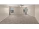 Spacious bedroom with plush carpeting, neutral walls, a ceiling fan, and two windows for natural light at 681 W Racine Loop, Casa Grande, AZ 85122