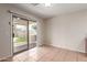 Bright dining area with tile flooring, sliding glass door to the backyard patio with artificial turf and grill at 681 W Racine Loop, Casa Grande, AZ 85122