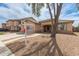 A single-story home featuring desert landscaping, a two-car garage, and a walkway leading to the entrance at 681 W Racine Loop, Casa Grande, AZ 85122