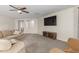A comfortable living room featuring a ceiling fan and large windows that let in lots of natural light at 681 W Racine Loop, Casa Grande, AZ 85122