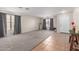 Spacious open-concept living area with neutral walls, carpet, and a ceramic tile entrance in a well-lit space at 681 W Racine Loop, Casa Grande, AZ 85122