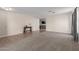 A spacious living room featuring neutral carpet, ceramic tile, and large windows that let in lots of natural light at 681 W Racine Loop, Casa Grande, AZ 85122