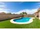 Backyard pool surrounded by lush, green artificial turf at 681 W Racine Loop, Casa Grande, AZ 85122