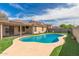 Inviting backyard pool with artificial turf offers a relaxing outdoor experience at 681 W Racine Loop, Casa Grande, AZ 85122