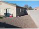 Gravel backyard with minimal maintenance, block wall, and exterior view of the home at 7118 S 37Th Gln, Phoenix, AZ 85041