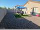 Gravel backyard features a BBQ, seating area with a blue awning, and privacy walls at 7118 S 37Th Gln, Phoenix, AZ 85041