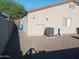 Wide-angle backyard shot with gravel, partial lawn, and AC unit at 7118 S 37Th Gln, Phoenix, AZ 85041
