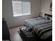 Neutral bedroom with a large window and a comfortable queen sized bed at 7118 S 37Th Gln, Phoenix, AZ 85041