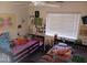 Bright bedroom with a ceiling fan, two twin beds, and lots of natural light at 7118 S 37Th Gln, Phoenix, AZ 85041