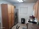 Well-lit kitchen with oak cabinets, stainless steel refrigerator, and modern appliances at 7118 S 37Th Gln, Phoenix, AZ 85041