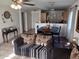 Cozy living room open to the dining area features stylish furniture and a ceiling fan at 7118 S 37Th Gln, Phoenix, AZ 85041