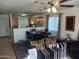 Open concept living room and kitchen area with tile flooring and neutral tones at 7118 S 37Th Gln, Phoenix, AZ 85041