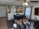 Open concept living room and kitchen area with tile flooring and neutral tones at 7118 S 37Th Gln, Phoenix, AZ 85041