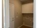 Functional laundry room with upper cabinets, neutral wall color, and utility connections at 7243 E Cattle Call St, San Tan Valley, AZ 85143