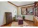 Cozy office space with Saltillo floors, natural light, and custom shelving at 7526 E Edgemont Ave, Scottsdale, AZ 85251