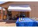 View of back patio featuring an awning, sliding glass door, and partial patio at 8012 S Magic Dr, Casa Grande, AZ 85193