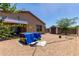 Backyard featuring a patio, gravel landscaping, and mature trees at 8012 S Magic Dr, Casa Grande, AZ 85193