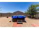 Backyard features a covered spa, gravel landscaping, block fencing, and a mature shade tree at 8012 S Magic Dr, Casa Grande, AZ 85193