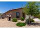 A low-maintenance yard surrounds this single-Gathering home with a window awning and plenty of greenery at 8012 S Magic Dr, Casa Grande, AZ 85193