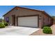 This desert home features a two-car garage, low-maintenance yard with gravel and desert landscaping adding to its curb appeal at 8012 S Magic Dr, Casa Grande, AZ 85193