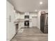 Modern kitchen featuring stainless steel appliances and sleek white cabinetry at 8012 S Magic Dr, Casa Grande, AZ 85193