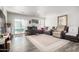 Spacious living room with ample seating, wood-look floors, and natural light coming in from the sliding glass door at 8012 S Magic Dr, Casa Grande, AZ 85193