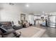 Open floor plan with wood-look floors and a living room that flows into a kitchen with white cabinets and stainless appliances at 8012 S Magic Dr, Casa Grande, AZ 85193