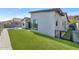 An inviting backyard featuring lush artificial turf, a gravel border, and a modern stucco home exterior at 812 E Summerside Rd, Phoenix, AZ 85042