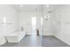 Modern bathroom with a separate shower, soaking tub, and sleek white tiling at 812 E Summerside Rd, Phoenix, AZ 85042