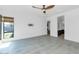 Large bedroom features tile flooring, a ceiling fan, and an entrance to the bathroom at 812 E Summerside Rd, Phoenix, AZ 85042