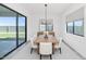 Modern dining room features a large table, neutral decor, and sliding glass doors at 812 E Summerside Rd, Phoenix, AZ 85042