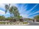 A decorative community entrance features desert landscaping and a striking metal gate under a bright sky at 812 E Summerside Rd, Phoenix, AZ 85042