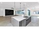 Kitchen island featuring a stainless steel sink and view of the living room at 812 E Summerside Rd, Phoenix, AZ 85042