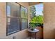 Cozy balcony with plants, table, and a view of lush greenery at 8787 E Mountain View Rd # 2100, Scottsdale, AZ 85258