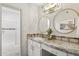 Elegant bathroom featuring dual round mirrors, granite countertop, and bright lighting at 8787 E Mountain View Rd # 2100, Scottsdale, AZ 85258