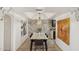 Dining room with stylish lighting, unique artwork, and laminate wood flooring at 8787 E Mountain View Rd # 2100, Scottsdale, AZ 85258