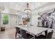 Dining room featuring stylish lighting, artwork, and laminate wood floors at 8787 E Mountain View Rd # 2100, Scottsdale, AZ 85258