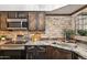 Well-equipped kitchen with stainless steel appliances, granite counters, and stylish wood cabinets at 8787 E Mountain View Rd # 2100, Scottsdale, AZ 85258