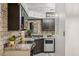 Beautiful kitchen featuring updated appliances, countertops, tile backsplash, and modern lighting at 8787 E Mountain View Rd # 2100, Scottsdale, AZ 85258