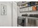 Convenient laundry room featuring modern washer/dryer and storage shelves for easy organization at 8787 E Mountain View Rd # 2100, Scottsdale, AZ 85258