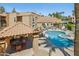 Beautiful community pool with cabana, lounge chairs, and lush landscaping at 8787 E Mountain View Rd # 2100, Scottsdale, AZ 85258