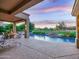 Beautiful back patio featuring a pool, golf course views, and outdoor seating area with fire pit at 9878 N 79Th Pl, Scottsdale, AZ 85258