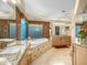 Luxury bathroom with a soaking tub, granite countertops, decorative tiling, and ample vanity space at 9878 N 79Th Pl, Scottsdale, AZ 85258