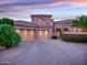 Attractive home exterior featuring a three-car garage, beautiful landscaping and elegant curb appeal at 9878 N 79Th Pl, Scottsdale, AZ 85258