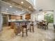 Well-lit kitchen with granite countertops, brick accents, breakfast bar, and an adjacent dining area bathed in natural light at 9878 N 79Th Pl, Scottsdale, AZ 85258