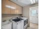 Convenient laundry room featuring Maytag washer and dryer with overhead cabinets and utility sink at 9878 N 79Th Pl, Scottsdale, AZ 85258